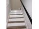 Staircase with white risers, wood treads and a black handrail at 258 Lincoln Sw St, Concord, NC 28025