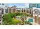 Lovely aerial view of the brick condos surrounding a beautifully landscaped community courtyard with a pool and fountain at 300 W 5Th St # 617, Charlotte, NC 28202