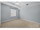 Bright bedroom with carpet, white walls, one window and a ceiling fan at 300 W 5Th St # 617, Charlotte, NC 28202