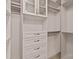 Custom walk-in closet with drawers, shelves, and hanging rods at 300 W 5Th St # 617, Charlotte, NC 28202