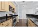 Contemporary kitchen featuring stainless steel appliances, granite countertops, and updated cabinetry at 300 W 5Th St # 617, Charlotte, NC 28202
