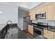 Updated kitchen with stainless steel appliances, granite countertops, and a breakfast bar at 300 W 5Th St # 617, Charlotte, NC 28202