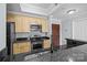 Modern kitchen featuring granite countertops, stainless steel appliances, and wooden cabinets at 300 W 5Th St # 617, Charlotte, NC 28202