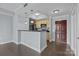 Open-concept kitchen with wooden cabinets and a breakfast bar seamlessly integrates with the living area at 300 W 5Th St # 617, Charlotte, NC 28202