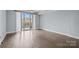 Sun-filled living room showcasing hardwood floors, a balcony with city views, and a ceiling fan at 300 W 5Th St # 617, Charlotte, NC 28202