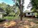 Spacious backyard with mature trees and a view of the shed and the house's back exterior at 310 E Houston St, Monroe, NC 28112