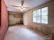 Unfinished basement area with a brick wall, concrete flooring, and a window for natural light at 310 E Houston St, Monroe, NC 28112