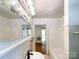 Bathroom with a sink, mirror, and white cabinets with floral decor and a view to the hallway at 310 E Houston St, Monroe, NC 28112