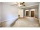 Large, bright bedroom with a ceiling fan and double closets; lots of potential at 310 E Houston St, Monroe, NC 28112