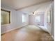 A large, light-filled bedroom boasts multiple windows and ample space with a neutral color palette at 310 E Houston St, Monroe, NC 28112