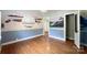 Charming bedroom featuring hardwood floors, hand painted wall murals, and a decorative chandelier at 310 E Houston St, Monroe, NC 28112