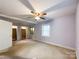 Spacious bedroom with a ceiling fan, two closets, and windows to let in natural light at 310 E Houston St, Monroe, NC 28112