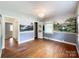 This room has hardwood floors, hand painted wall murals, two windows, and a decorative chandelier at 310 E Houston St, Monroe, NC 28112