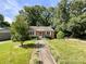 Charming home with a well-manicured lawn, mature trees, and welcoming curb appeal at 310 E Houston St, Monroe, NC 28112