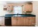 This kitchen features light wood cabinets with dark countertops and a window overlooking the sink at 310 E Houston St, Monroe, NC 28112