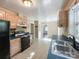 The kitchen boasts light wood cabinets, black appliances, and tile flooring at 310 E Houston St, Monroe, NC 28112