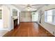 Bright living room featuring hardwood floors, fireplace, and built-in shelving at 310 E Houston St, Monroe, NC 28112