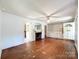 Open living room with hardwood floors, fireplace, and built-in shelving at 310 E Houston St, Monroe, NC 28112