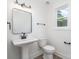 Modern bathroom with a pedestal sink, sleek fixtures, and a large mirror at 318 Sixth St, Belmont, NC 28012