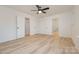A spacious bedroom with wood-look floors, ceiling fan, closet and bathroom access at 318 Sixth St, Belmont, NC 28012