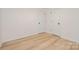 Neutral bedroom featuring wood-look flooring, two closets, and white doors at 318 Sixth St, Belmont, NC 28012