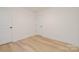 Bright bedroom with wood-look floors and a white door at 318 Sixth St, Belmont, NC 28012