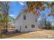 New two-story home featuring light gray siding, a back door, a small backyard, and a well-manicured lawn at 318 Sixth St, Belmont, NC 28012