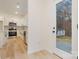 Bright kitchen features stainless steel appliances, wood floors, white cabinets, and access to the outdoors at 318 Sixth St, Belmont, NC 28012
