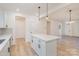 Modern kitchen with stainless appliances and center island open to the living room at 318 Sixth St, Belmont, NC 28012