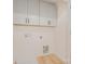 Laundry room featuring gray cabinets, washer hookups, and wood-look floors at 318 Sixth St, Belmont, NC 28012