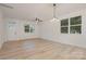 Bright and spacious living room with tile floors and large windows, perfect for modern living at 318 Sixth St, Belmont, NC 28012