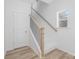 Bright staircase with wooden handrail and white risers, leading to the upper level at 318 Sixth St, Belmont, NC 28012