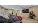 Basement bedroom features a large TV, exercise equipment, and neutral paint with carpeted floor at 360 Lake Landing Dr, Salisbury, NC 28146