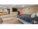 Cozy basement bedroom boasts large TV, neutral paint, carpet flooring, and comfortable sleeping area at 360 Lake Landing Dr, Salisbury, NC 28146