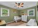 Cozy bedroom with a crib, dresser, and a ceiling fan, providing a comfortable atmosphere at 360 Lake Landing Dr, Salisbury, NC 28146