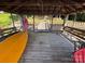 Covered dock featuring seating, a canoe, and lake access at 360 Lake Landing Dr, Salisbury, NC 28146