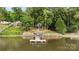 Waterfront home with beautiful lake views featuring a private dock and covered seating area at 360 Lake Landing Dr, Salisbury, NC 28146