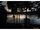 A peaceful sunset over a tranquil lake, with a dock and boathouse, framed by silhouetted trees at 360 Lake Landing Dr, Salisbury, NC 28146