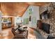 Inviting living room showcases a wood ceiling, stone fireplace, kitchen, and outdoor access at 360 Lake Landing Dr, Salisbury, NC 28146