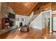 Cozy living room boasts a stone fireplace, wood ceiling, and staircase to the upper level at 360 Lake Landing Dr, Salisbury, NC 28146