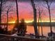 Scenic waterfront view, highlighting the dock's seating area at sunset at 360 Lake Landing Dr, Salisbury, NC 28146