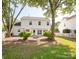 Spacious backyard with a well-maintained lawn, and a fire pit surrounded by mature trees at 411 Carlisle Dr, Indian Trail, NC 28079