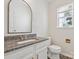 Elegant half bathroom featuring a granite countertop vanity, modern fixtures, and a decorative mirror at 411 Carlisle Dr, Indian Trail, NC 28079