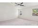 Bright bedroom with neutral carpet, vaulted ceiling, two windows, and ceiling fan at 411 Carlisle Dr, Indian Trail, NC 28079