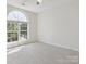 Serene bedroom with carpet, large window providing natural light, base molding, and outlets at 411 Carlisle Dr, Indian Trail, NC 28079