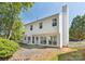Rear view of a two-story white house with a chimney, sliding glass doors, and fenced yard perfect for relaxing and entertaining at 411 Carlisle Dr, Indian Trail, NC 28079