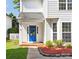 Close-up of the home's front entrance, showcasing a vibrant blue door, white trim, and a neatly landscaped walkway at 411 Carlisle Dr, Indian Trail, NC 28079