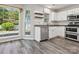Cozy kitchen featuring stainless appliances, white cabinetry, granite countertops, and natural light from the windows at 411 Carlisle Dr, Indian Trail, NC 28079