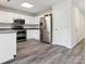 Bright kitchen featuring stainless steel appliances, granite countertops, and white cabinetry at 411 Carlisle Dr, Indian Trail, NC 28079
