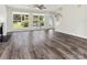 Open-concept living space featuring hardwood floors, a ceiling fan, fireplace and a staircase, creating a welcoming ambiance at 411 Carlisle Dr, Indian Trail, NC 28079